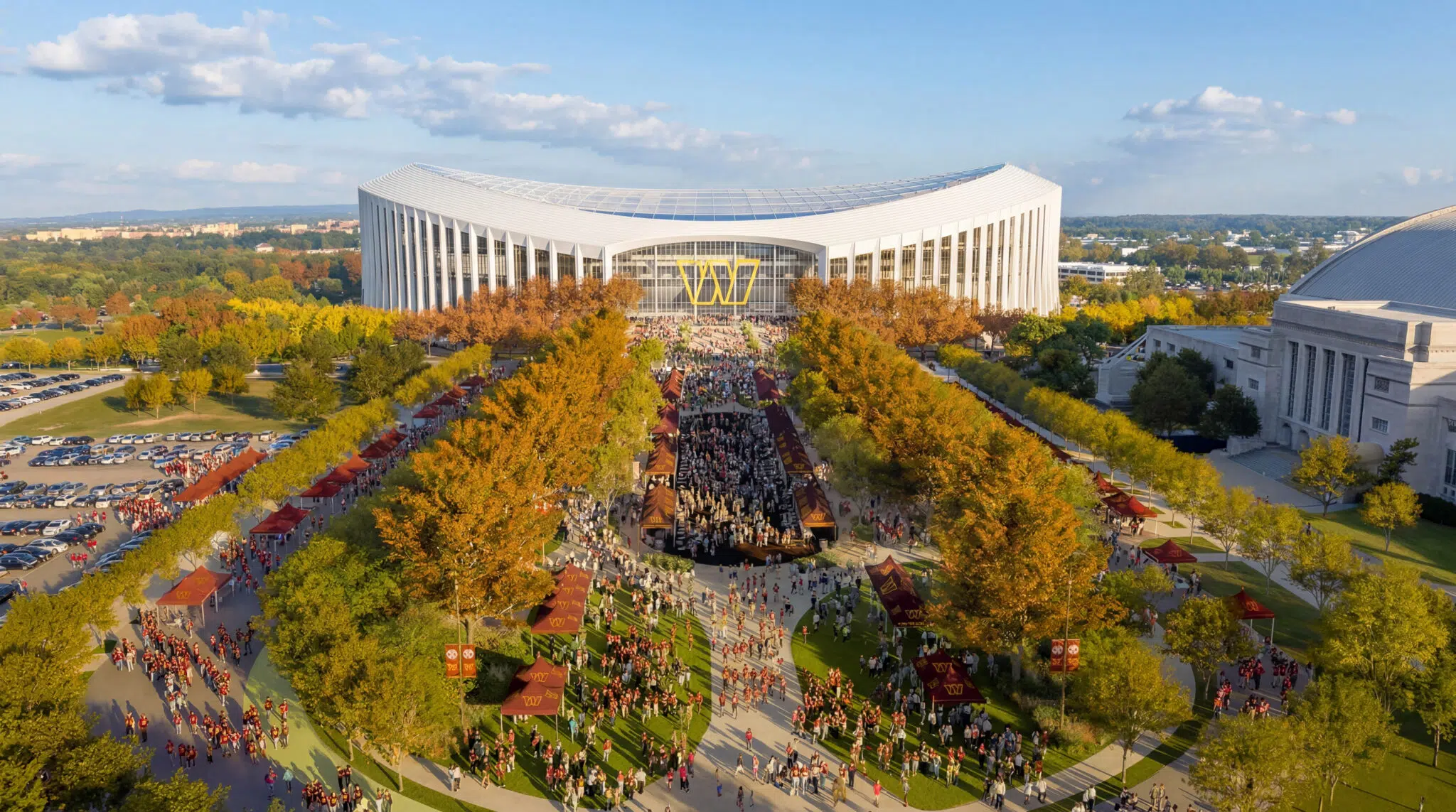 Aerial rendering of the Washington Commanders stadium festival plaza, with allées of shade trees framing a central gathering space and tailgate area.