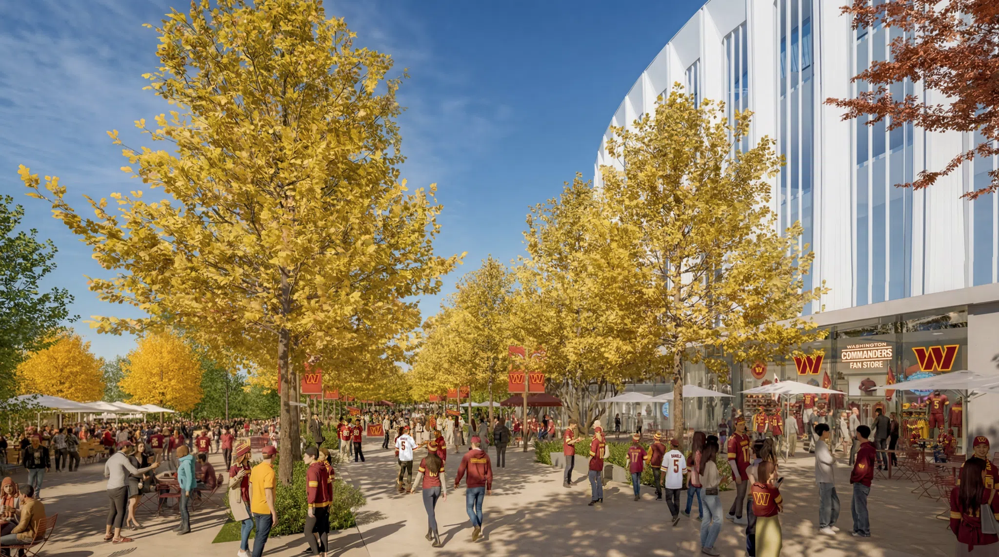 Stadium promenade at the Washington Commanders stadium, lined with ginkgo trees and active retail edges that extend the public realm beyond game day.