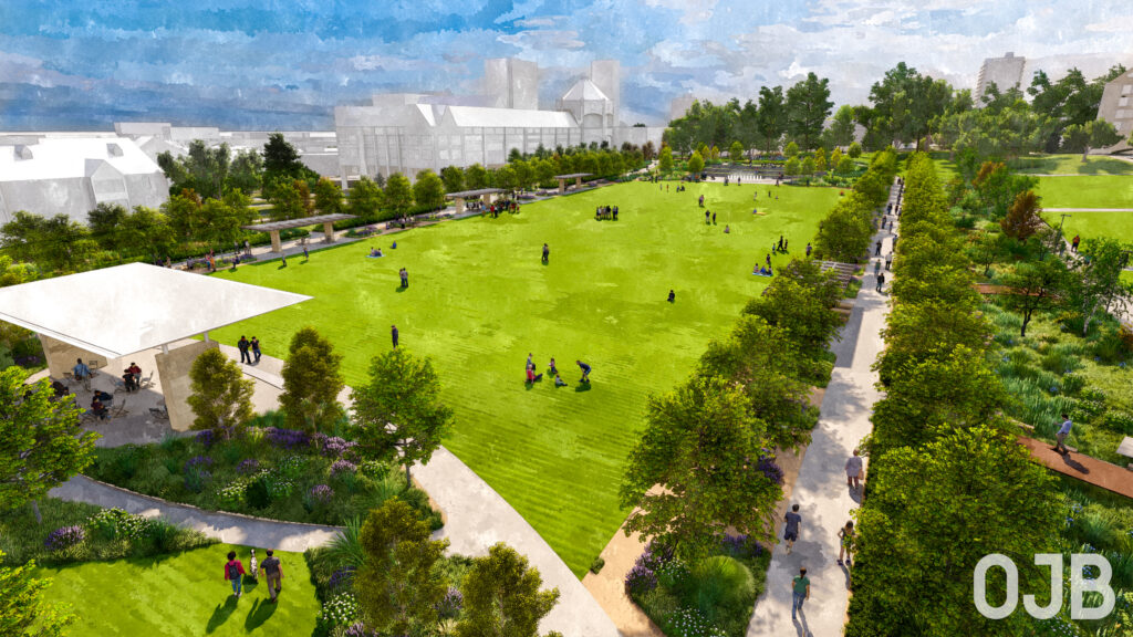 Creighton Univ Quadrangle - View 1 Lush green park with people picnicking and walking, surrounded by trees and pathways, under a clear blue sky.